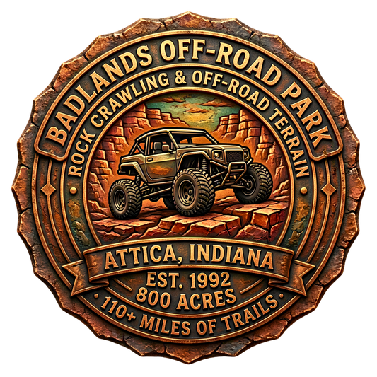 3D etched circular badge for Badlands Off-Road Park in Attica, Indiana, featuring a rugged off-road buggy over red rock terrain with carved banners showing park name, location, acreage, and trail miles in aged brass and clay tones.