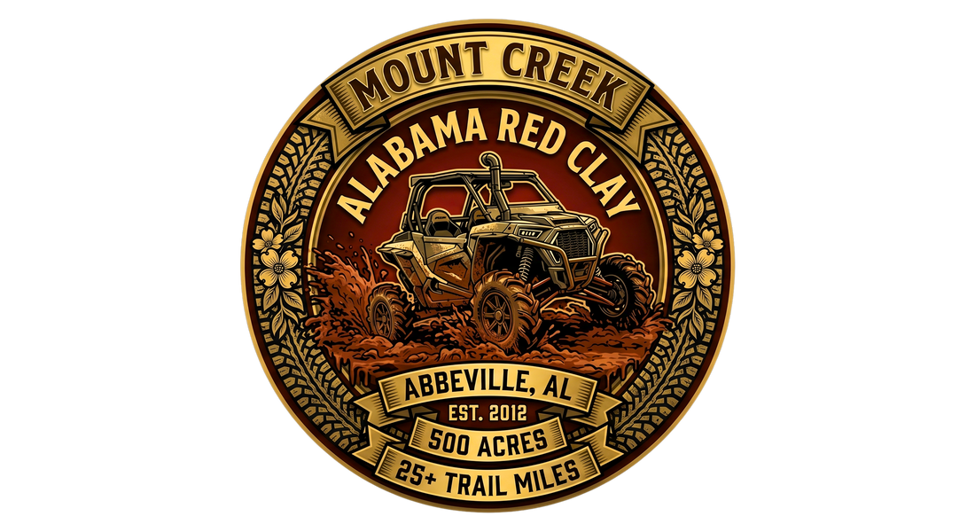Off‑road logo for Mount Creek Alabama Red Clay in Abbeville, featuring a mud‑splattered ATV driving through deep red clay inside a gold floral emblem with details noting 500 acres, 25+ trail miles, and est. 2012.